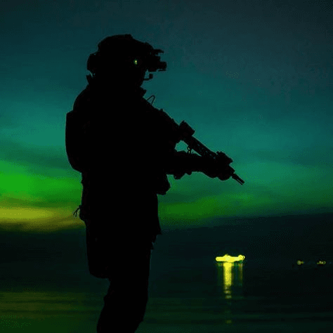 Operator silhouetted on a coastal night watch